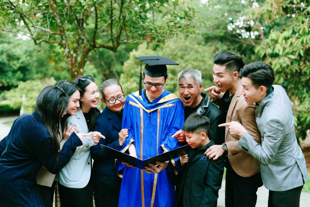 Tan Kim and family laughing over his UUM scroll at Kepong Botanical Garden