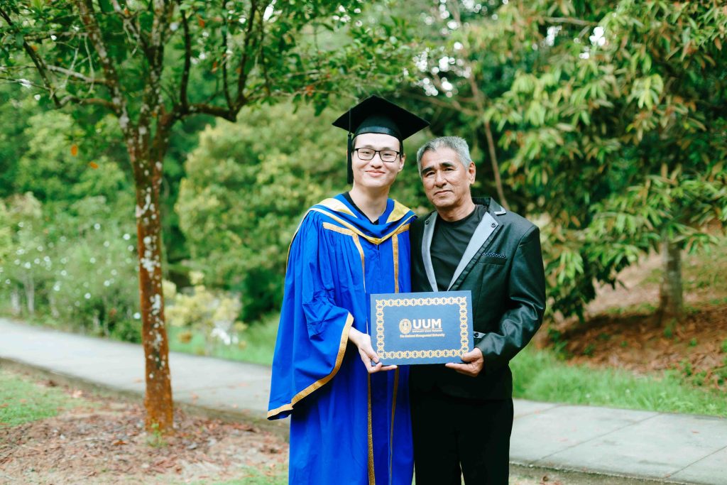 UUM graduate Tan Kim with his father, outdoor convocation photoshoot in Kepong